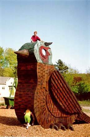 image of two children playing on a large sculpture of a bird at grizedale forest visitor centre in the lake district