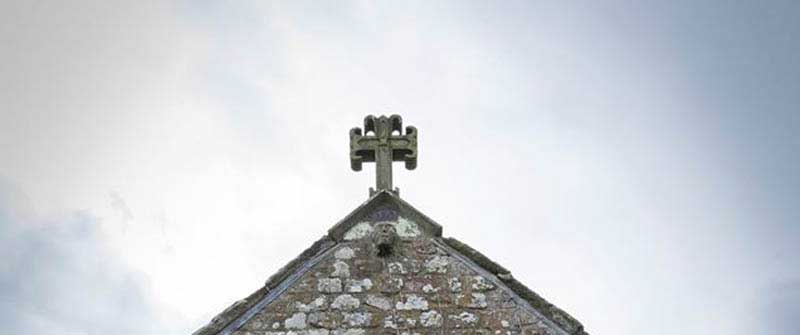 image of a stone head, possibly pagan, on St Mary's Church, Gilcrux
