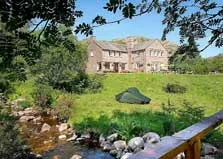 image of a tent beside a stream in a campsite in the Lake District
