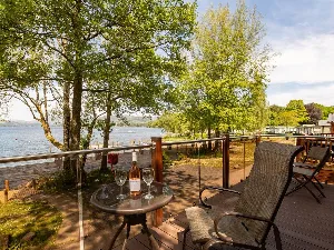 image of the view from shoreside lodge, in the fallbarrow holiday park in the lake district. the image shows the balcony and the shore of Windermere lake