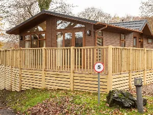 Image of the exterior of westbrook lodge, in fallbarrow park in the lake district in the image you see the decking patio