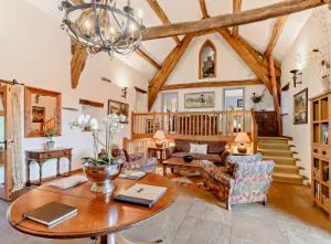 image of the lounge with exposed wooden beams at Thorphinsty Barn holiday cottage in Cumbria