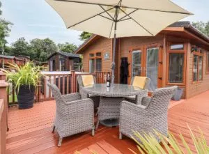 image of the outside seating on the decking at dog friendly Black Dog Lodge near Windermere in the Lake District