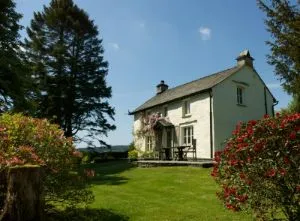 image of Croft Head, a pet-friendly cottage in the Lake District, sitting in a large lawned garden