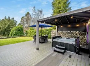 Luxury Lake District villa with covered hot tub, landscaped gardens, and marina views
