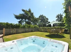 Hot tub in a private garden at Sala Cottage, a luxurious Lake District retreat on the Edenhall Estate with modern-retro interiors
