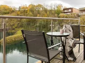 Stylish lodge with open hot tub and terrace overlooking a former quarry in the Lake District