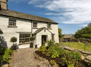 Traditional whitewashed cottage near Cartmel Fell in Cumbria