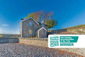 Traditional stone cottage with an open hot tub overlooking the countryside near Coniston Water
