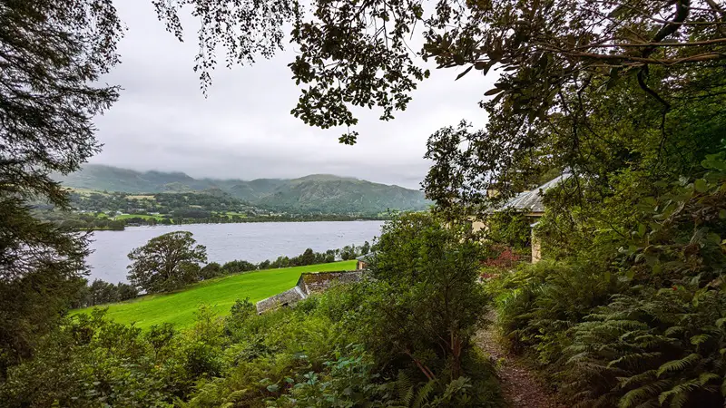 image of the Gardens of Brantwood, photo shows the lake in the background with the gardens behind.