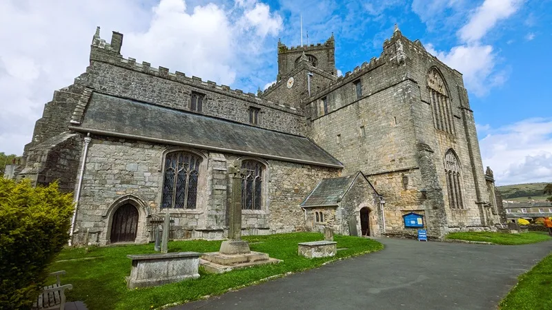 image of cartmel priory, with blue sky in the background