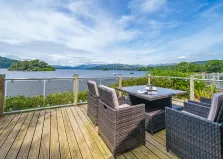 Image of a lake from a deck with outdoor seating area