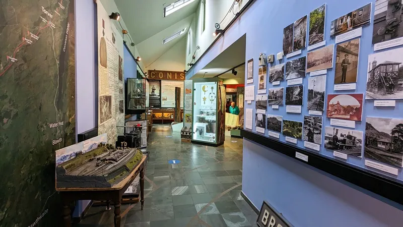 image of the interior of the museum, photo shows photos on the right and a model on the left