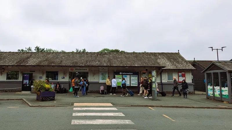 image of the the railway station with a few people stood outside waiting for a train