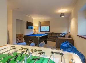 image shows the games room at Swarthbeck family friendly cottage in the Lake District with a table football table and pool table